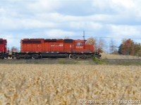 <b>SD40-2 Hustles</b> by hues of brown and orange as fall has set in Puslinch, Ontario. This classic motive power clearly in its final years on the roster, but earning its keep 36 years later.