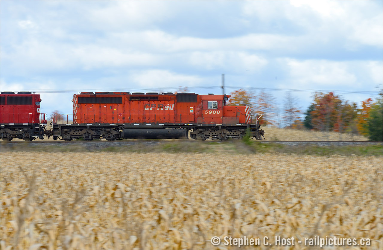 SD40-2 Hustles by hues of brown and orange as fall has set in Puslinch, Ontario. This classic motive power clearly in its final years on the roster, but earning its keep 36 years later.