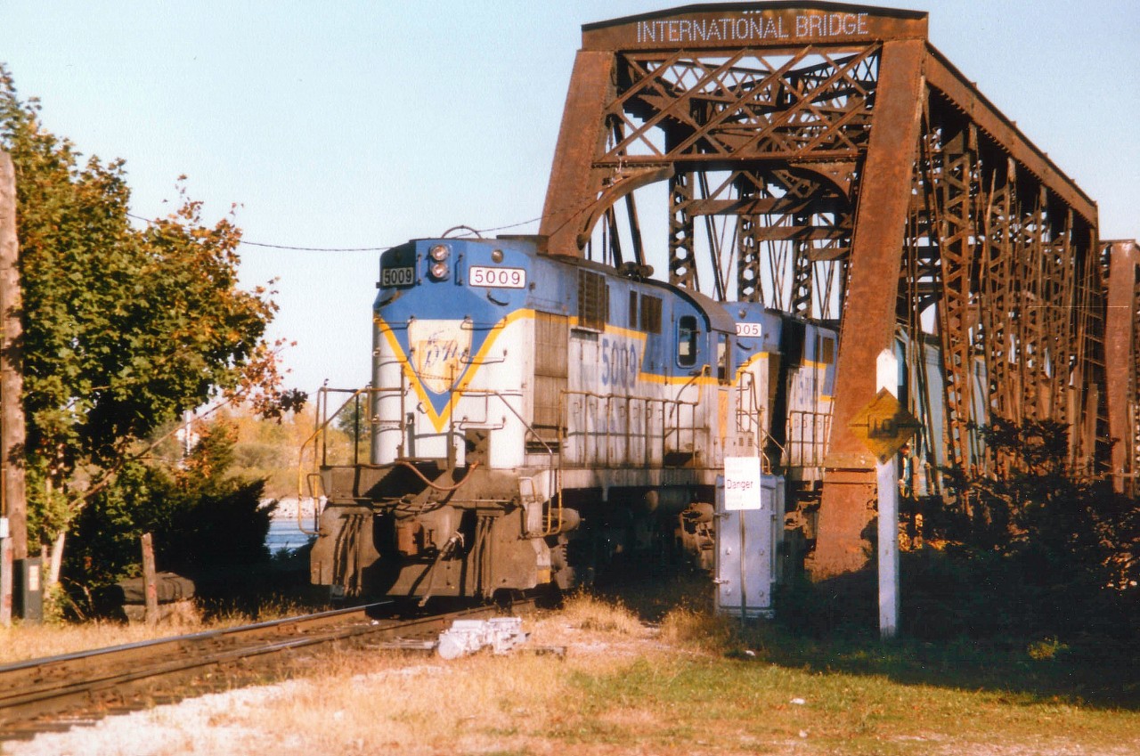 One of the great pastimes for train nuts like myself was wandering down to that once busy CN facility at Fort Erie and watching to see whose power would be on the daily transfers. Usually it would be Conrail, often Norfolk Southern and perhaps Chessie. But surprises abound. One of the better power combos for me, because I am a D&H fan, was this pair of RS-11s, D&H 5009 and 5005 shown here just setting foot on Canadian soil. This photo as I post it was taken just a couple of days over 30 years ago; and as of last month most of the D&H as I knew it was spun off to the NS. Life along the Susquehanna Valley in NY state will never be the same. :o( I have lost track of the travels of these units, which left the D&H probably 20 years ago; and wonder if they have met the scrapper and lost.  They were built in 1961.