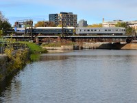 <b>Not one, but two private cars bringing up the rear.</b> The southbound Adirondack has just left Montreal's Central station, and is crossing over the Lachine canal with two private cars: <i>Ohio River</i> and <i>Babbling Brook</i> bringing up the rear as they pass the closed Wellington tower. Built by Budd for the New York Central's Boston-Chicago <i>New England States</i>, the <i>Babbling Brook</i> has a Canadian connection as CP bought it from NYC in 1959 and they sold it to Quebec Cartier Mining Company in 1969.