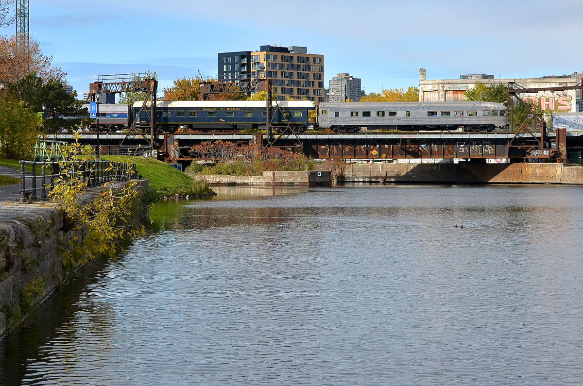 Not one, but two private cars bringing up the rear. The southbound Adirondack has just left Montreal's Central station, and is crossing over the Lachine canal with two private cars: Ohio River and Babbling Brook bringing up the rear as they pass the closed Wellington tower. Built by Budd for the New York Central's Boston-Chicago New England States, the Babbling Brook has a Canadian connection as CP bought it from NYC in 1959 and they sold it to Quebec Cartier Mining Company in 1969.