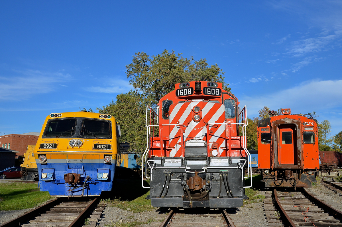 Lined up at Exporail. LRC-3 VIA 6921, GP9 CP 1608 and MU car CN 6734 are lined up around the turntable at Exporail.