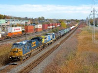<b>Marker lights plated over.</b> While many of CSXT's ex-Conrail Dash8-40CW's still have their marker lights visible in the nose (click <a href="http://www.railpictures.ca/?attachment_id=21160">here</a> for an example), the marker lights on CSXT 7313 have been plated over. CSXT 7313 (ex-CR 6084) looks rather worse for wear as it leads CN 327 with a standard cab Dash8 trailing (CSXT 7538) through Pointe-Claire on CN's Kingston sub. At left CP 112 is eastbound on the parallel CP Vaudreuil sub.