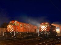 <b>Class lights lit on a pair of MLW Centuries, a bit of smoke too.</b> MLW's CP 4237 (C424) and CP 4563 (M630) both have their class lights lit as part of the 'Illuminated Trains' night shoot at Exporail. Both units are idling so there is some smoke as well.