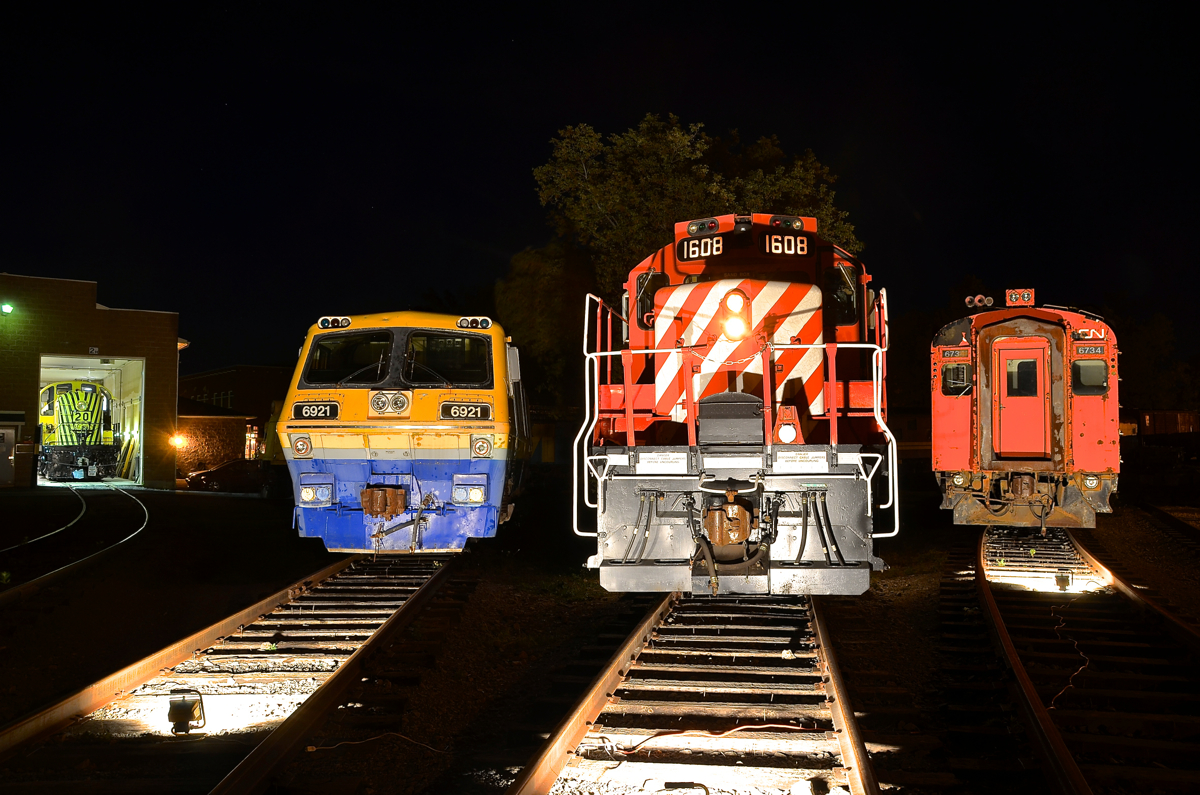 Ready for their closeup. LRC-3 VIA 6921, GP9 CP 1608 and MU car CN 6734 are lined up around the turntable at Exporail  as part of the 'Illuminated Trains' night shoot. Visible at left is RS-2 RS 20.