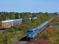 <b>VIA 55 and CP 112.</b> VIA 55 is westbound on CN's Kingston Sub as the tail end of CP 112 passes on the parallel CP Vaudreuil Sub
