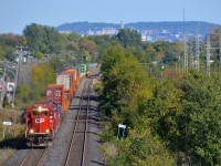 <b>Back to back ex-SOO SD60's.</b> After entering Montreal on CP 142, ex-SOO Line SD60's CP 6223 and CP 6256 are heading back west on 142's counterpart, CP 143 as they round a curve in Pointe-Claire. This intermodal train is majority non-intermodal traffic this time, with autoracks seen at the rear of the photo, and mixed freight out of sight behind.