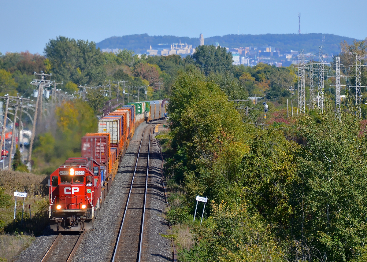 Back to back ex-SOO SD60's. After entering Montreal on CP 142, ex-SOO Line SD60's CP 6223 and CP 6256 are heading back west on 142's counterpart, CP 143 as they round a curve in Pointe-Claire. This intermodal train is majority non-intermodal traffic this time, with autoracks seen at the rear of the photo, and mixed freight out of sight behind.
