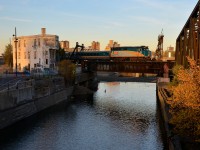 <b>Last light.</b> It's about 45 minutes before sunset and there's still enough sun (barely) to illuminate VIA 6409 as it leads VIA 37 past the Wellington tower and over the partially drained Lachine Canal.