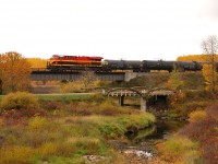 In a beautiful fall scene KCS 4858 shoves CP 298 over the creek in Elfros, SK