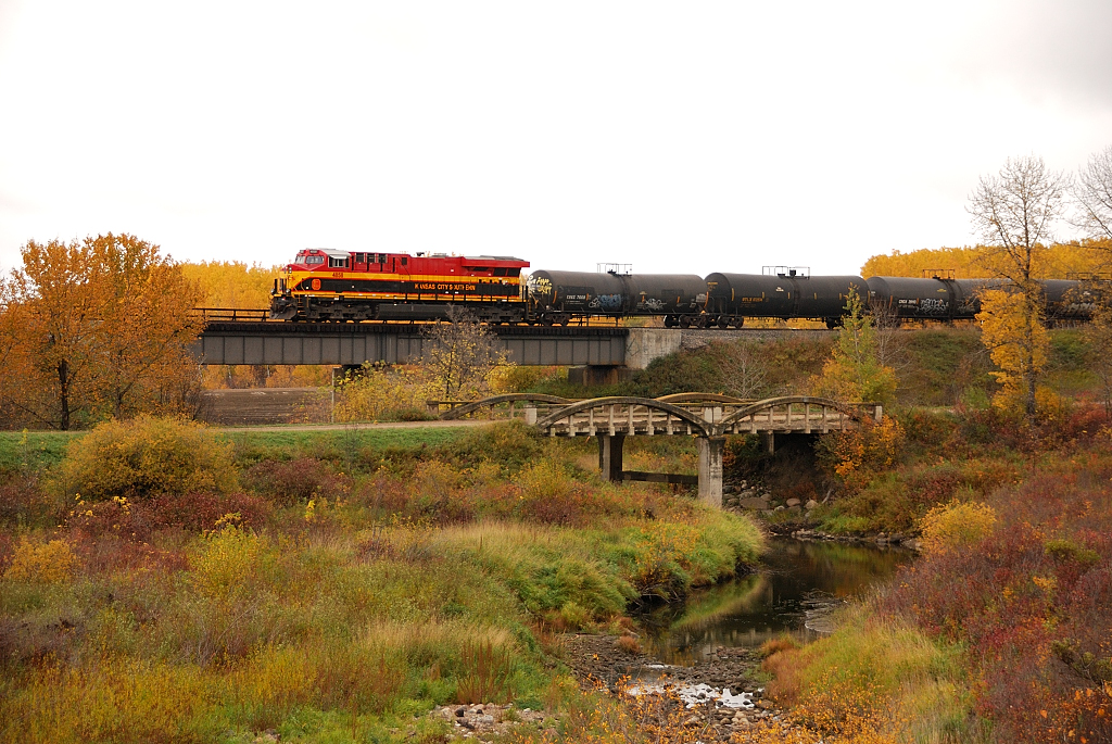 In a beautiful fall scene KCS 4858 shoves CP 298 over the creek in Elfros, SK