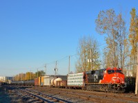 <b>A fresh ES44AC on a sunny morning.</b> On a cloudless morning CN 310 with clean CN 2937 at the head end is approaching Southwark Yard where it will do a setoff before continuing to Joffre Yard with a new crew. Operating mid-train is CN 2901.