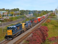 <b>A SpongeBob SquareCab leader in Montreal.</b> Railfans have dubbed CSXT's SD40-3 rebuilts as 'SpongeBob SquareCab' and here one of them leads a varied CN 327 lashup through Pointe-Claire. Full lashup is SD40-3 CSXT 4067, Dash8-40CW CSXT 7744, Dash9-44CW CN 2550 and GP38-2W CN 4775. For the records, all four units were running. Probably one or both of the CN units was set off at Coteau.