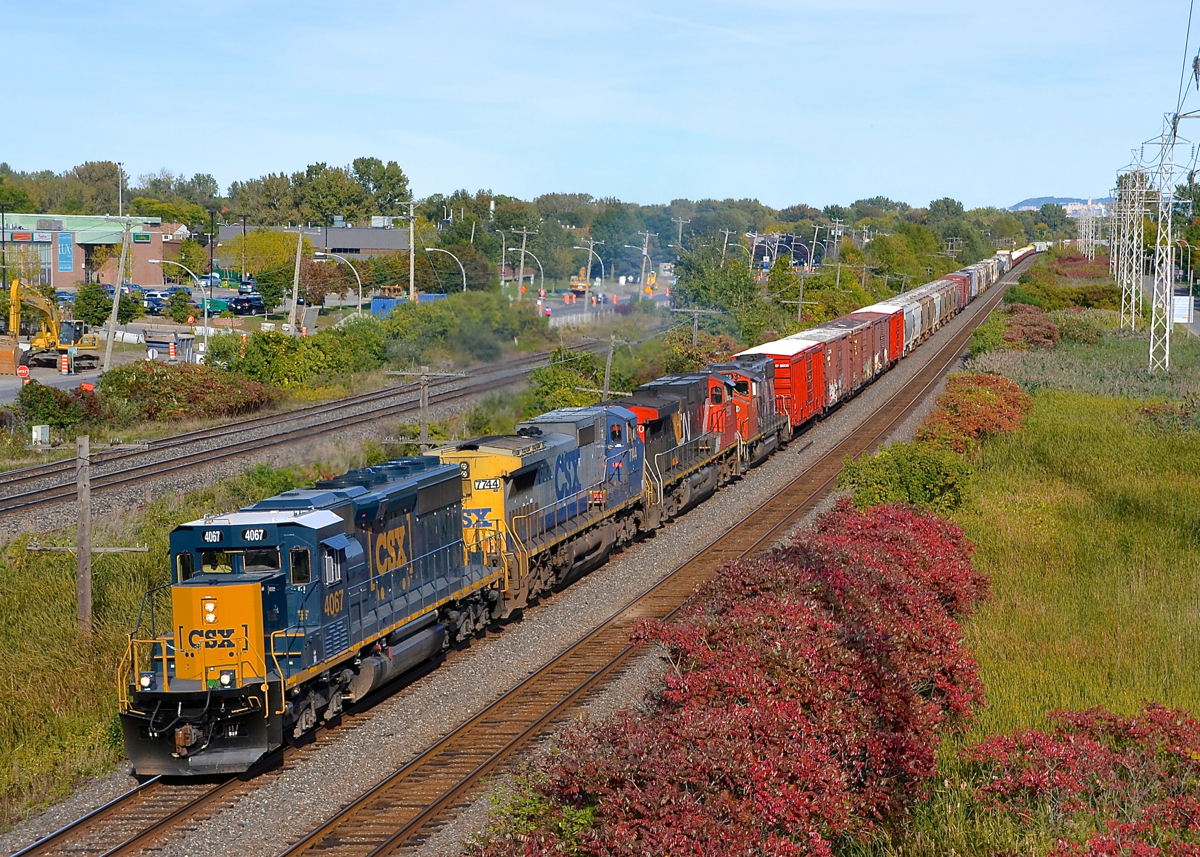 A SpongeBob SquareCab leader in Montreal. Railfans have dubbed CSXT's SD40-3 rebuilts as 'SpongeBob SquareCab' and here one of them leads a varied CN 327 lashup through Pointe-Claire. Full lashup is SD40-3 CSXT 4067, Dash8-40CW CSXT 7744, Dash9-44CW CN 2550 and GP38-2W CN 4775. For the records, all four units were running. Probably one or both of the CN units was set off at Coteau.