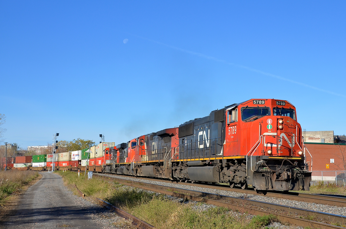 Not an AC unit in sight. CN 120 has often had solid AC lashups composed of ES44AC's and/or ET44AC's recently, but not this morning. On a sunny morning (with the moon visible) CN 120 rounds a curve in the St-Henri neighbourhood of Montreal with four DC units (CN 5789, CN 2686, CN 2246 & CN 2600).