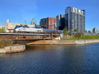 <b>Past Wellington Tower.</b> AMTK 72 pushes the empty <i>Adirondack</i> towards Montreal's Central station about 80 minutes before its 1020 departure, passing Wellington Tower at left in the process.