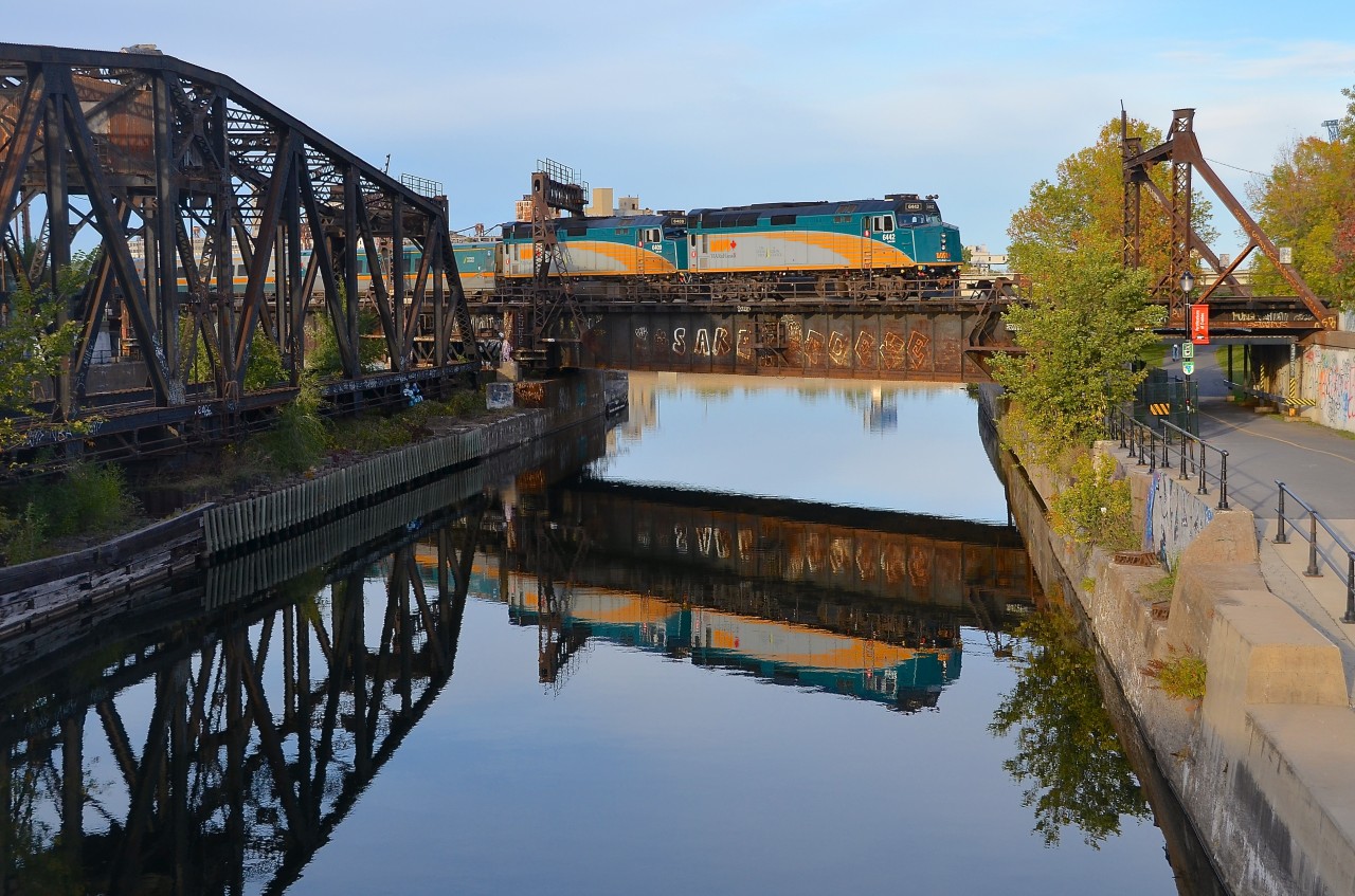A pair of F40's reflected. VIA 6442 & VIA 6409 are at the head end of VIA 37 which has 3 LRC cars followed by 3 RDC's as it crosses the Lachine canal 5 minutes after leaving Central Station in Montreal.