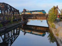 <b>A pair of F40's reflected.</b> VIA 6442 & VIA 6409 are at the head end of VIA 37 which has 3 LRC cars followed by 3 RDC's as it crosses the Lachine canal 5 minutes after leaving Central Station in Montreal.