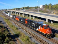 <b>A trio of brand new ET44AC's.</b> A trio of brand new ET44AC's (CN 3028, CN 3033 & CN 3030) lead CN 120 by MP6 of CN's Montreal sub on a sunny but crisp morning.