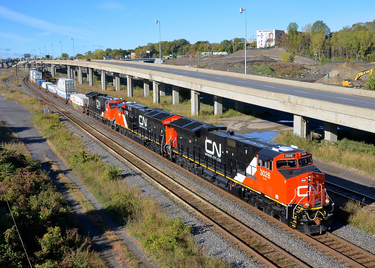 A trio of brand new ET44AC's. A trio of brand new ET44AC's (CN 3028, CN 3033 & CN 3030) lead CN 120 by MP6 of CN's Montreal sub on a sunny but crisp morning.