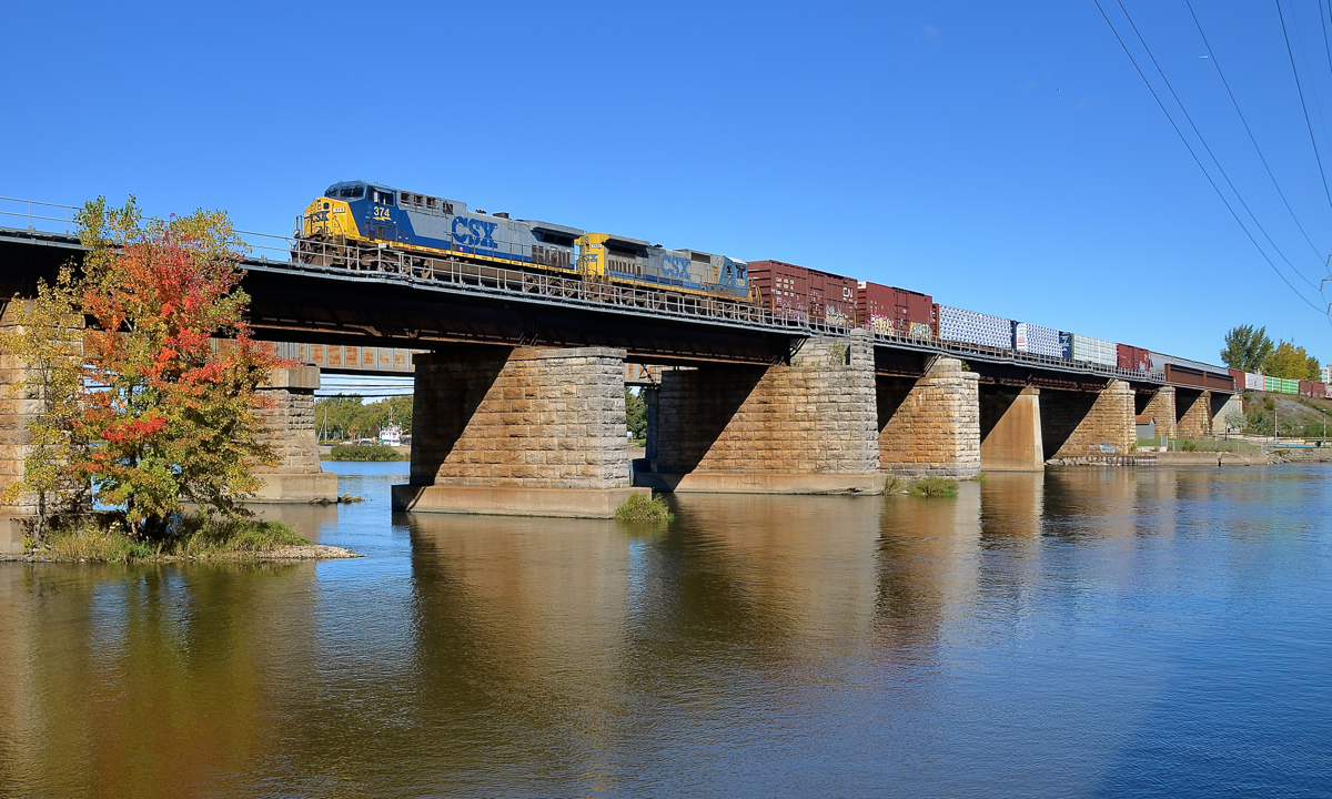YN2 X 2 A matched pair of CSXT YN2-painted engines has become harder to find, but here two of them (CSXT 374 & 7532) lead CN 327 over the Ottawa River as they leave Montreal.