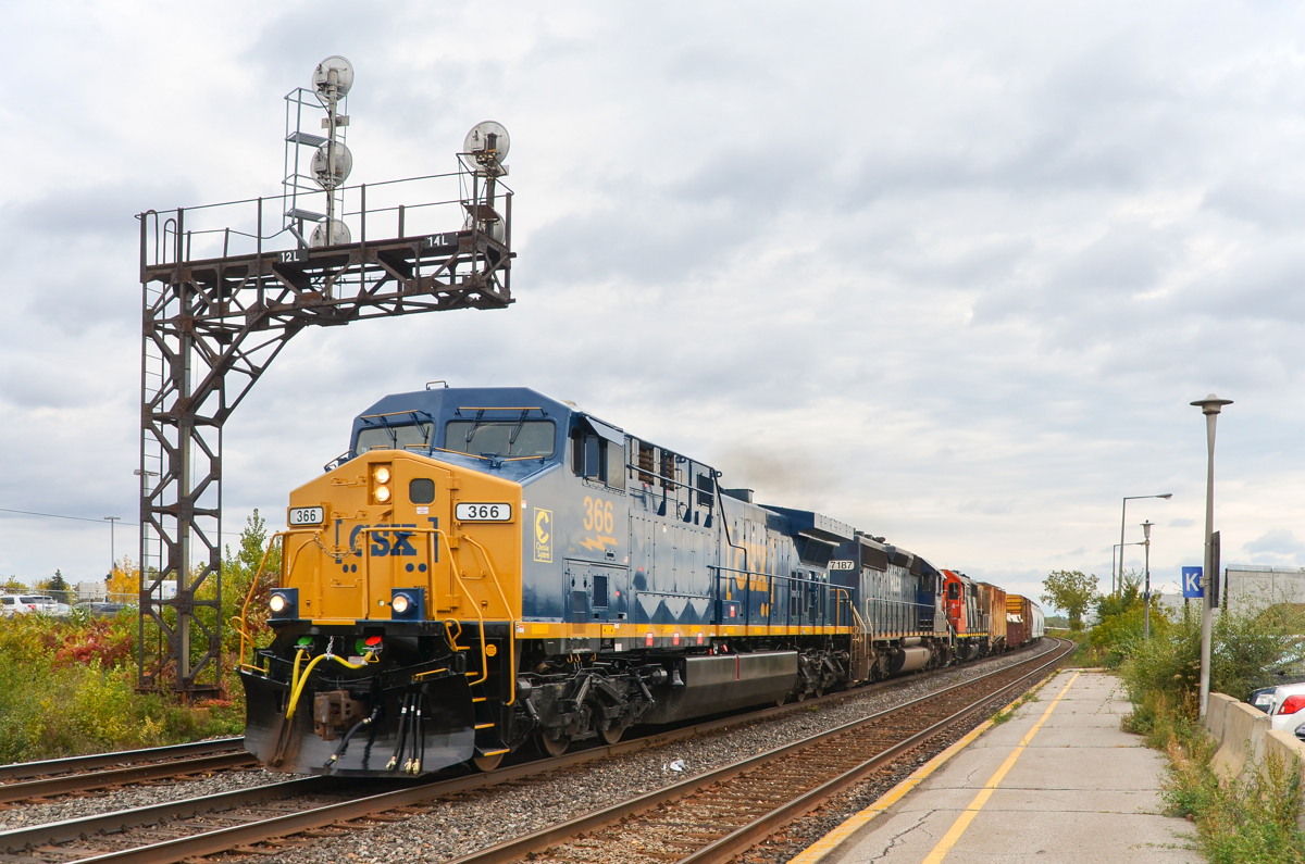 CSXT's Chessie unit in Montreal. Fresh out of the paint booth, CSXT 366 (with 'Chessie System' decal applied on the nose) leads CN 327 through Dorval. Trailing are two veteran EMD units (ex-BN SD40-2 HLCX 7187 and GP38-2 CN 4703).