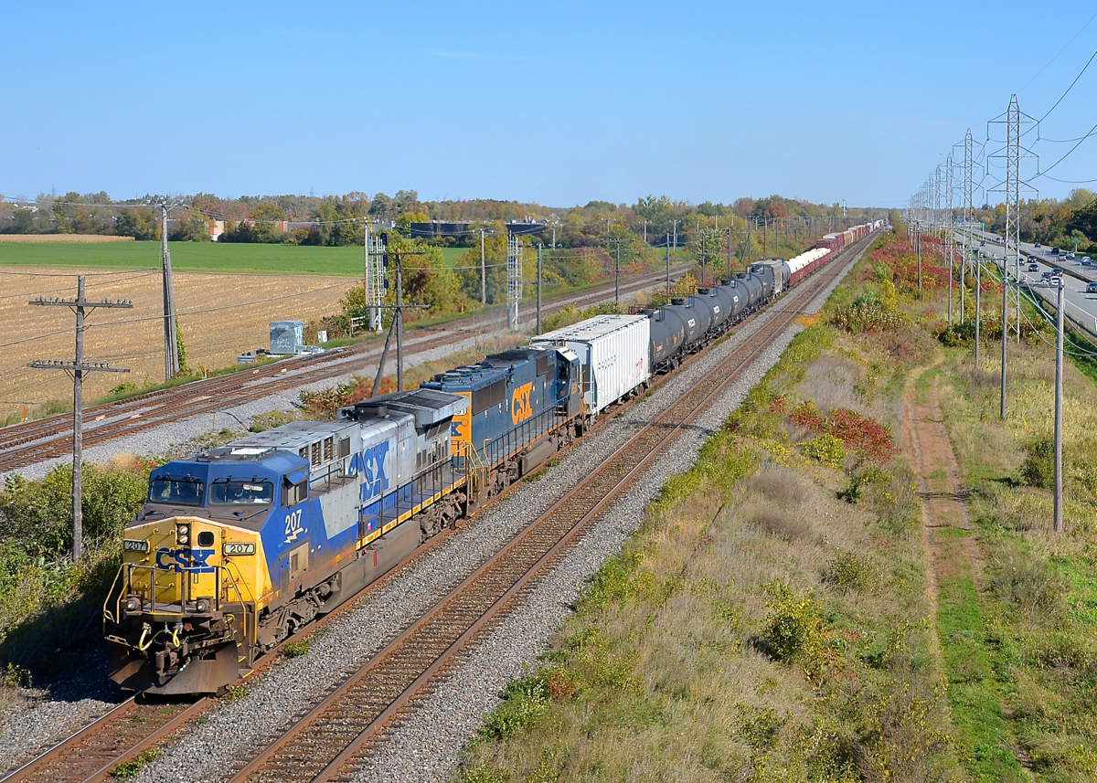 The Kingston and Vaudreuil subs side by side. AC4400CW CSXT 207 and SD50-2 CSXT 8591 lead CN 327 through Sainte-Anne-de-Bellevue on CN's Kingston Sub at the western tip of the island of Montreal. At left is CP's parallel Vaudreuil Sub.