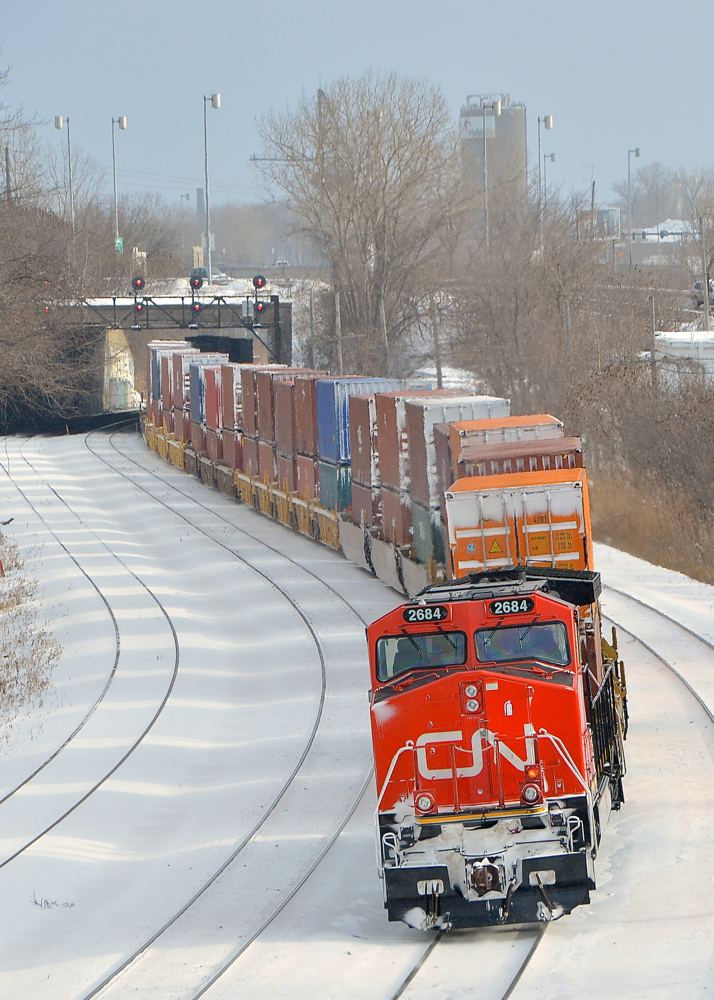 Marker light lit. On January 7th, 2014, CN 2684 was the DPU on CN 308 when it derailed in Plaster Rock, NB. A couple of weeks later it was brought to CAD in Lachine for repair. Here it is back in service with a fresh coat of paint. It is the rear DPU on CN 120 and so the marker light is lit. Head end power is CN 2228.