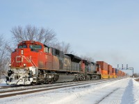<b>Snow on the plow.</b> CN 149 with CN 8957 & IC 2706 are westbound through Coteau.