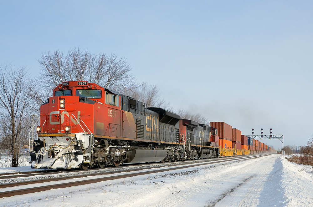 Snow on the plow. CN 149 with CN 8957 & IC 2706 are westbound through Coteau.