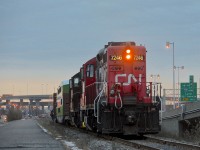 <b>Sunset on the CN Lachine Spur.</b> CN 7246 & CN 7229 are both long hood forward as they shove the Pointe St-Charles switcher westbound on the Lachine spur, bound for Canadian Allied Diesel, which is where GOT 2415 is bound. A crewmember rides the first car as the train heads towards the sunset. The sun has since set on CN's Lachine spur, with the track this train is on already torn up during the past week.