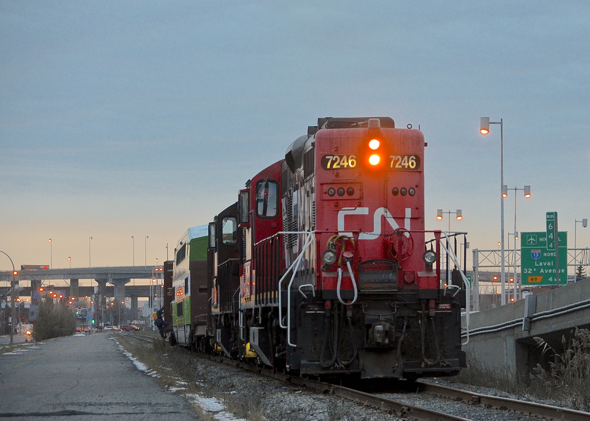 Sunset on the CN Lachine Spur. CN 7246 & CN 7229 are both long hood forward as they shove the Pointe St-Charles switcher westbound on the Lachine spur, bound for Canadian Allied Diesel, which is where GOT 2415 is bound. A crewmember rides the first car as the train heads towards the sunset. The sun has since set on CN's Lachine spur, with the track this train is on already torn up during the past week.