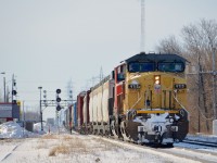 <b>Backing up.</b> A ratty looking UP Dash9 (UP 9715) is teamed up with CN 2252 on CN 326 which is backing up on the Kingston sub in Coteau to do a pickup. The conductor can be seen on the rear of the train.