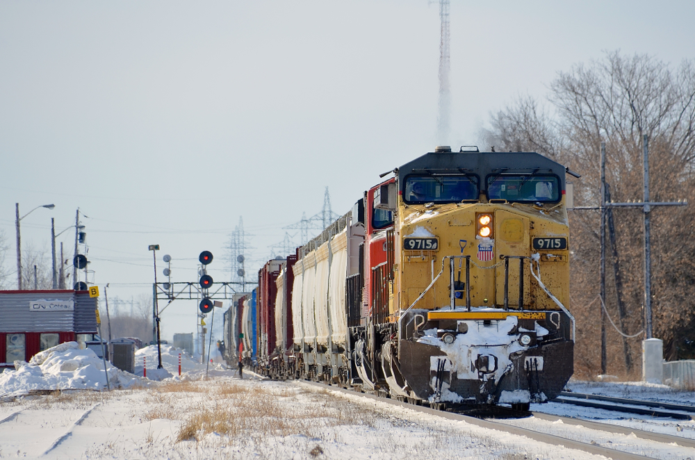Backing up. A ratty looking UP Dash9 (UP 9715) is teamed up with CN 2252 on CN 326 which is backing up on the Kingston sub in Coteau to do a pickup. The conductor can be seen on the rear of the train.