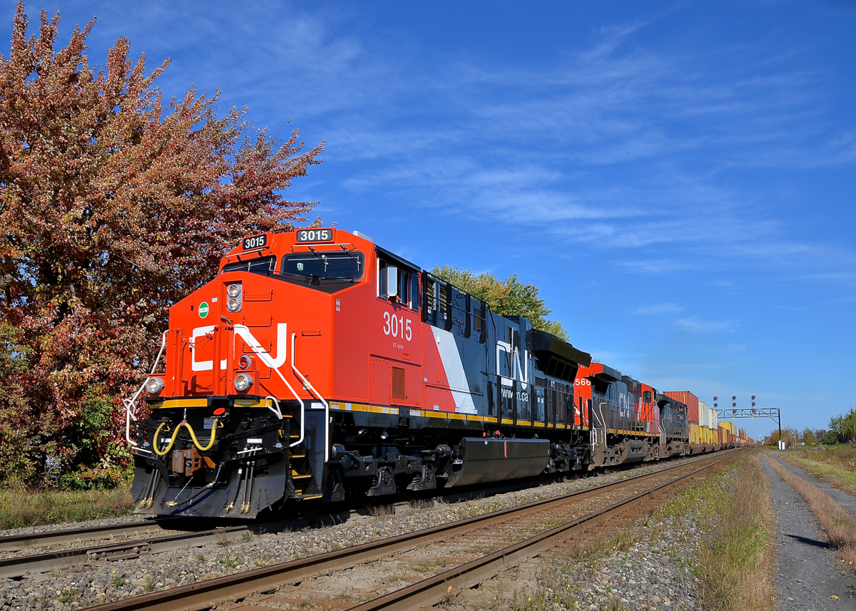 A fresh GE leading two older Dash9's. An extremely late CN 149 is through Coteau with brand new CN 3015 leading older Dash9-44CW's CN 2566 & BCOL 4651.