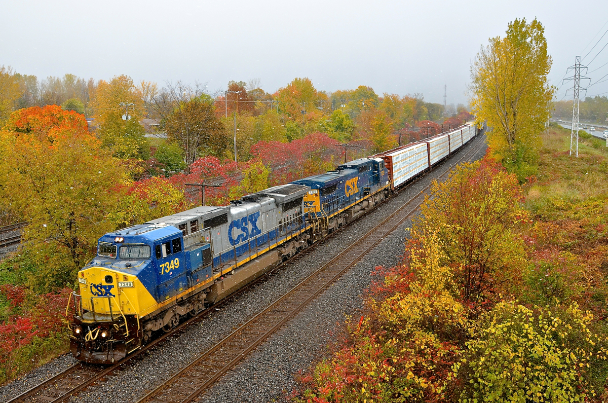 Fall colours and snow. CN 327 has a pair of ex-Conrail Dash8-40CW's in two paint schemes as it heads west through Beaconsfield with an even 400 axles. Fall colours are still present, but so was some snow.... though the sun would shine brightly ten minutes later on a topsy-turvy day for the weather in Montreal.