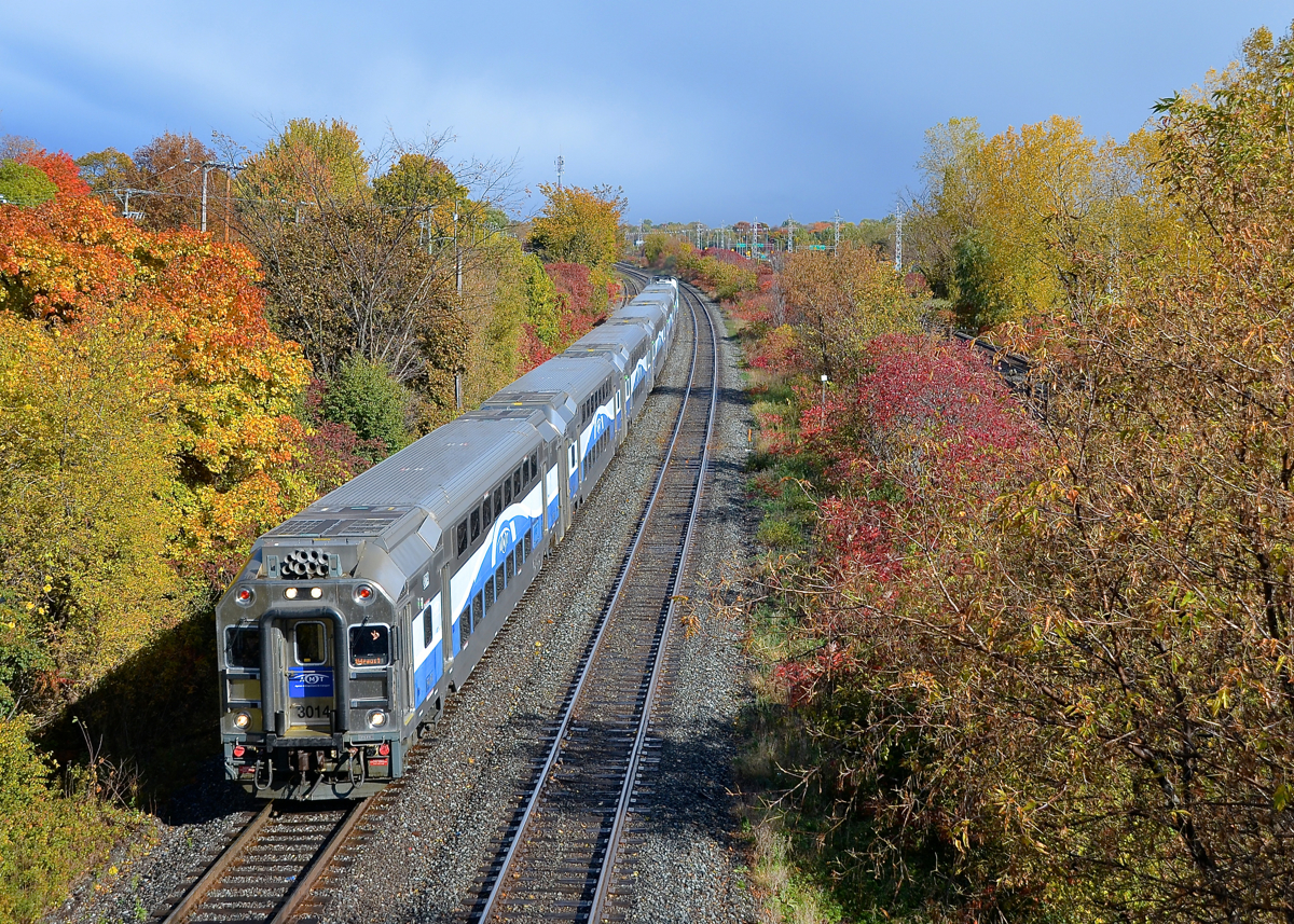 AMT amidst some fall colours. AMT 53 is through Beaconsfield led by cab car AMT 3014 and pushed by F59PHI AMT 1325.