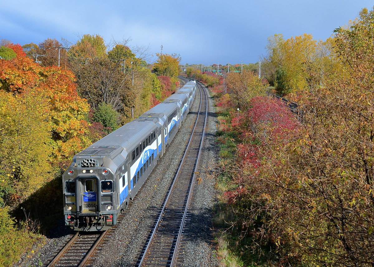 AMT amidst some fall colours. AMT 53 is through Beaconsfield led by cab car AMT 3014 and pushed by F59PHI AMT 1325.