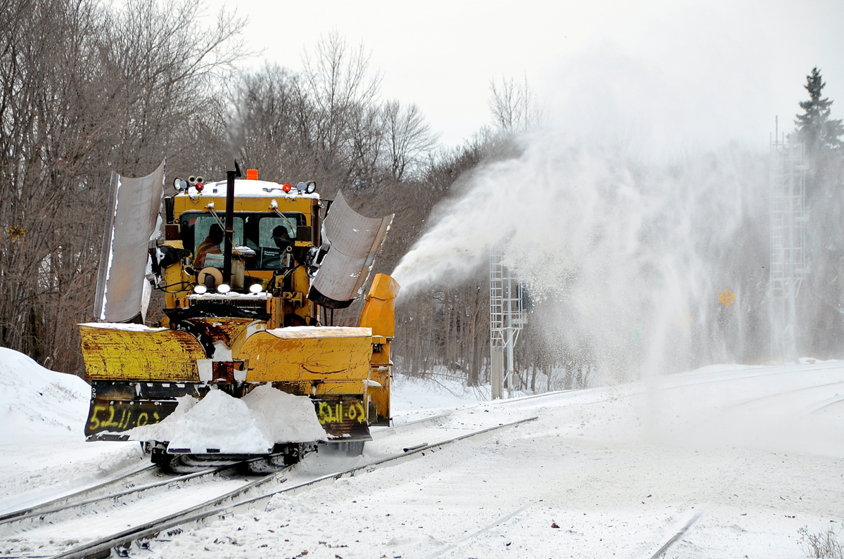 Clearing a switch.A regulator that has been retrofitted with snow plows and a blower attachment for winter is about to drop down the South Junction lead in Montreal West.