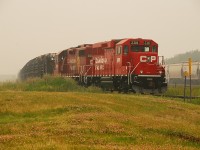 Forest Fire smoke blankets the area as a CP CWR train awaits a crew. The rail on this train was pulled up off the Gravelbourg Sub and will be used on CP's Tisdale Sub. 