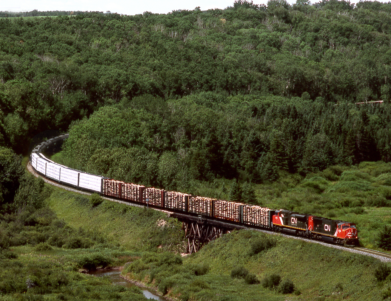 Eastbound mixed freight on CN's Prairie North Line crosses Boggy Creek near the Saskatchewan Border