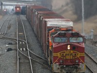 Sunday morning Warbonnet foreign power: CN train 391 backs on to his train at Snake after lifting some hi-cube auto parts cars in Aldershot yard;  bound for Ford in St Thomas.  BNSF 743 / 5424 ; CN auto train 271 is approaching in the background.