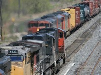 Everything happens at once....setting up on the Lemmonville Road bridge to shot an "A-A-A" lashup of cowls on a westbound.....an eastbound appeared with a colorful lashup - CN SD75 / UP-SP C44 / UP C44 / CN SD40. If CP'9000's are referred to as barns...why aren't CN's nicked the same ? : )  