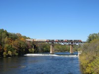 CN 2454 leads CN 382 over the Grand River in Paris, Ontario. After taking an awful long time to get from London to Paris, this was only the 3rd CN freight in the Woodstock, Paris, Brantford and Copetown area, from 7:35 AM to 2:00 PM. 331 and 148 were the only others. Actual fall colours appear on the trees this time, and the peaceful water rushes under the steel beast on the bridge. 