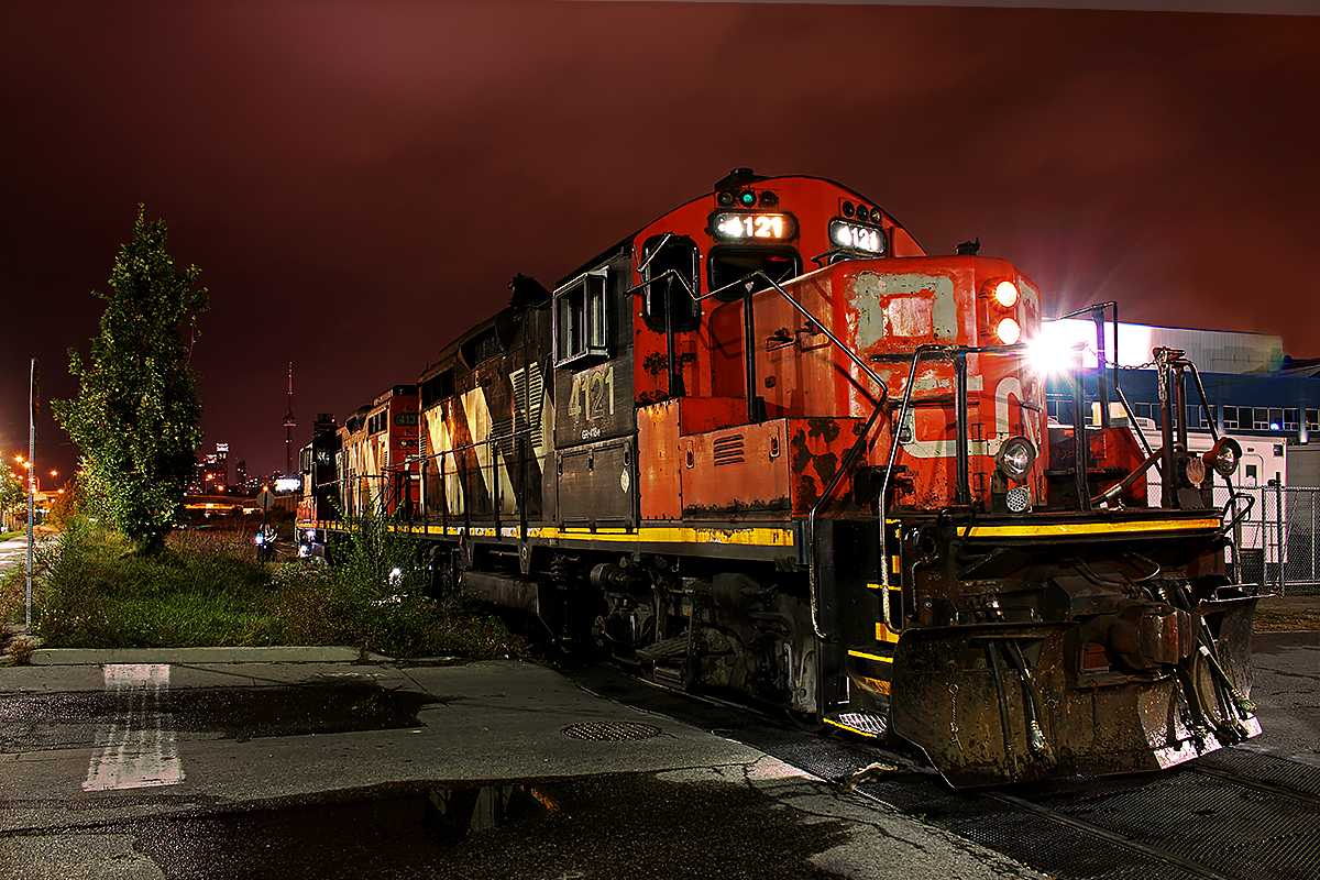 CN 543 makes its weekly appearance in the Portlands. CN 4121 and 4138 (AP unit) are the power on this job. 543 has dropped its cars from Mimico, and will reverse around the train to pick up tankers for Canroof, one of only two customers on the Portlands Spur. The other being the Ashbridge's Bay treatment plant, which receives chlorine. 543 pauses on the Booth Avenue crossing temporarily, with the CN tower in the background. Unlike most nights, it is not lit, which I think is beneficial to this shot actually. As one of the more discreet freight operations in Toronto, with only two customers left on the spur getting service once a week, it is hard to say how much longer this spur will remain in service.