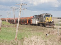 Drumheller Sub rail removal train on a gloomy day. Loaded train will drop the caboose at Dinosaur Junction, then continue to Drumheller for the night. The following day will go to Calgary, drop off full train, pick up empty and the process continued.. 