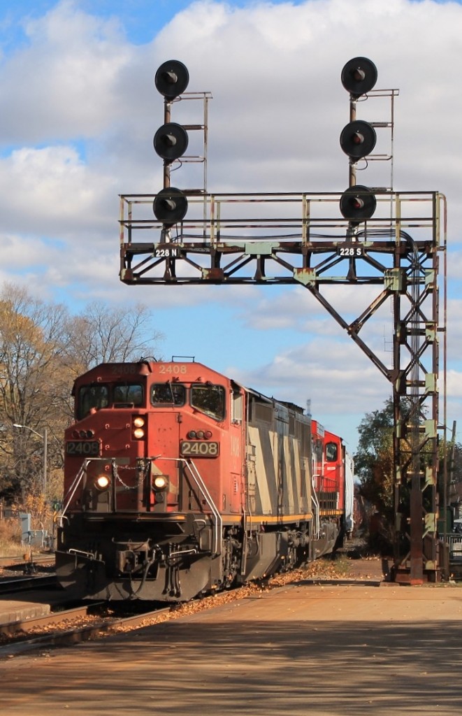 331 slowly passing under the signals as it enters the station.