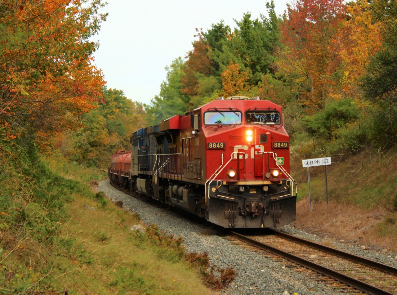 With the days shortening and the cold air upon us, fall colours surround CP 8849 and CEFX 1059 as the head out of Guelph Junction and make their way down the Hamilton Sub with their manifest of mixed freight.