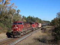After coming up from Hamilton, CP 9840 leads CP 8919 over side road 20 in Puslinch with its load of empty ethanol cars. New rails and rail plates are already in place for replacement in the near future. Two of the few remaining old tie piles are still here as crews work their way down the Galt sub removing them.