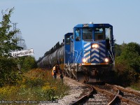 These are the weirdest engines I have ever set my eyes on. CEFX 2019 and 2014 lead this long consist of tanker cars bound for the Imperial Oil facility and Ontario Power Generating Station at Nanticoke. I was lucky this day in chasing a local train on the Southern Ontario Railway as it stopped just on the outskirts of the Imperial Oil facility. As I took this photo, the conductor had hopped out to unlock the switch - which they would use on the return trip from OPG to unload some tanker cars off on the storage yard just to the west. However, I still couldn't figure out why this train stopped at the name sign. Approximately half an hour later, a change in crew had arrived and the train proceeded to OPG.
